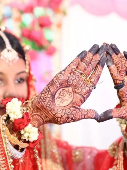 A beautiful shot of the bride showcasing her husband's name written in elegant script within her palm. It's a classic and romantic tradition.