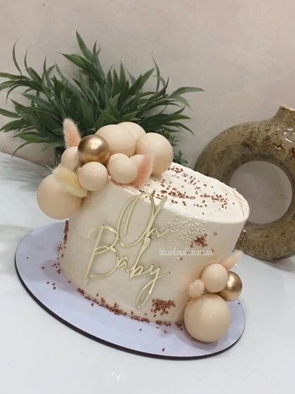 Another angle of the sophisticated gender-neutral baby shower cake.