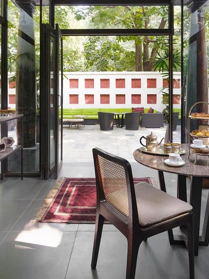 The glass-enclosed gazebo attached to the bedroom is a charming space for intimate meals. It’s an indoor-outdoor retreat that allows you to enjoy the verdant courtyard in any weather.