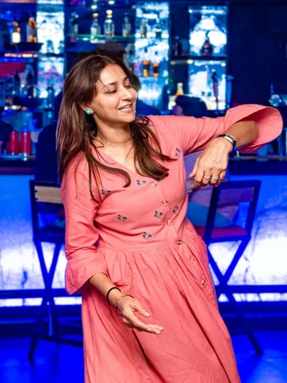 A woman enjoying a solo dance, lost in the music. The dance floor is a place to let go and be yourself.