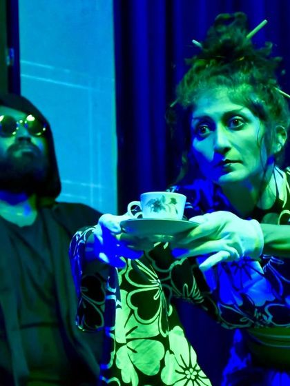 A scene from "No Strings Attached" where my character serves tea. The play uses humor and surreal situations to comment on modern life, relationships, and technology.