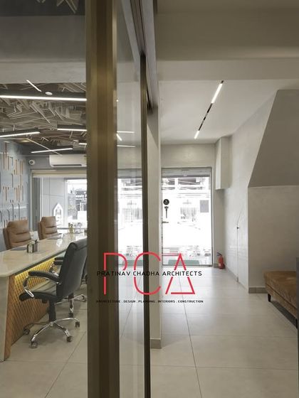 An alternate view of the conference room and adjacent corridor at StyleIn Homes, showcasing the cohesive design language across different zones.