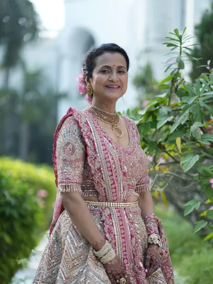 A full-length view of her stunning pink lehenga. The makeup is kept soft and natural to balance the intricate embroidery and heavy jewellery.