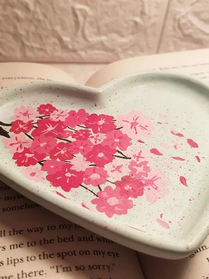 A side view of our hand-painted cherry blossom heart tray in mint green. It took over an hour to paint this delicate design.