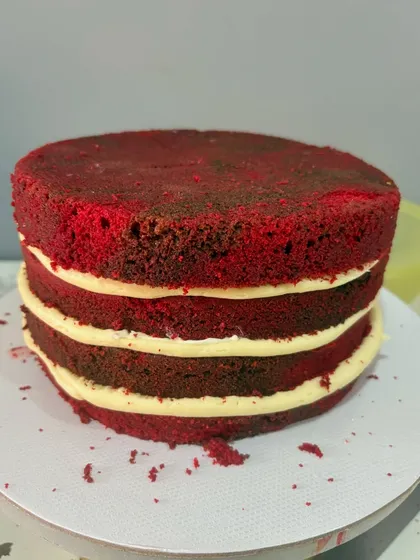 The beautiful layers of a classic red velvet cake with cream cheese frosting, ready to be frosted and decorated. This bestseller is loved for its moist texture and perfect balance of flavors.