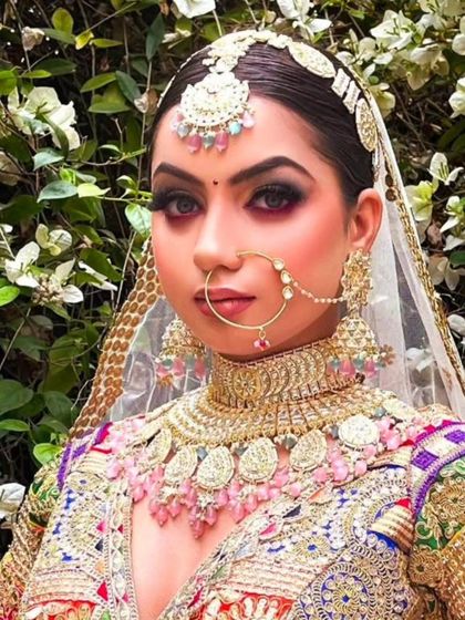 A unique and colorful bridal look. The model wears a multi-colored jewellery set that perfectly complements her vibrant lehenga.