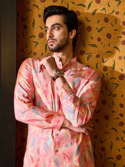 A three-quarter shot highlighting the beautiful print and the mandarin collar of the pink kurta.
