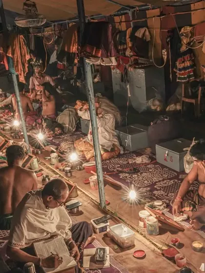 This is the 'chowki', the backstage world of Yakshagana. I spend hours here, observing the artists prepare. This wide shot shows the community and quiet dedication before the grand performance, all lit by simple bulbs, which is a story in itself.