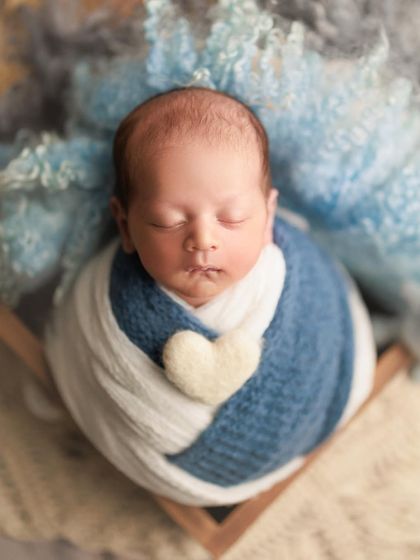 A beautiful combination of blue and white wraps creates a lovely layered effect. The little felt heart adds a sweet, loving touch.