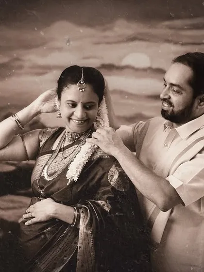A vintage-style black and white photo of a couple sharing a tender moment. This sepia-toned image feels like a cherished memory from a classic film.