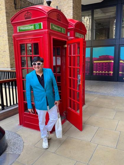A classic London moment with the iconic red phone booth. The city's landmarks provide the perfect backdrop for a stylish photo.