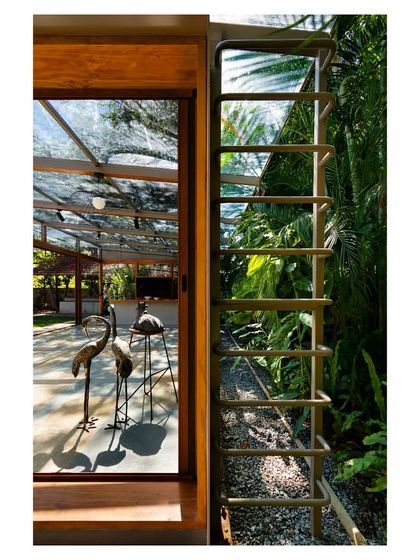 A custom-designed steel ladder provides access to the roof for maintenance, its form adding a subtle industrial detail to the structure.