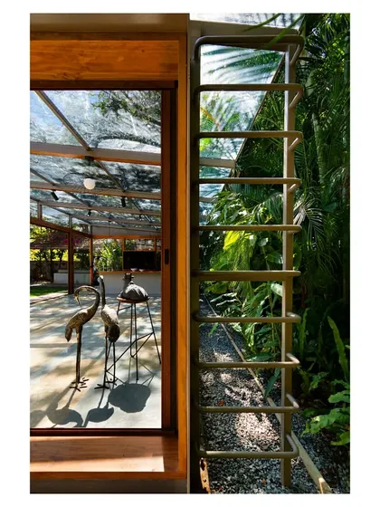 A custom-designed steel ladder provides access to the roof for maintenance, its form adding a subtle industrial detail to the structure.