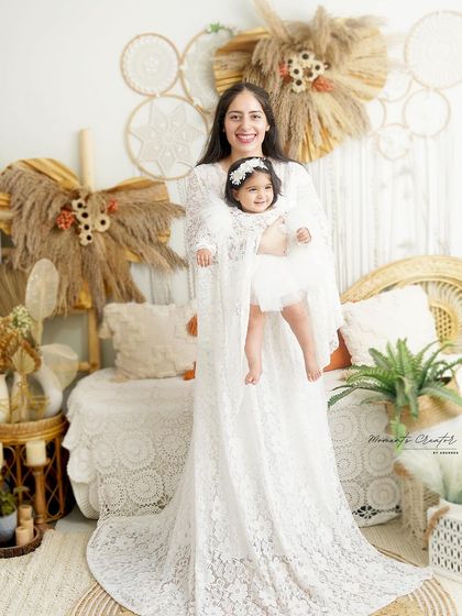 A mother and daughter twinning in beautiful white lace. This portrait, set against a boho backdrop, is soft, dreamy, and full of love.