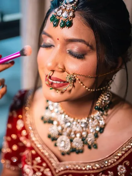 A close-up of the makeup application process, showing the attention to detail that goes into creating a flawless bridal look.