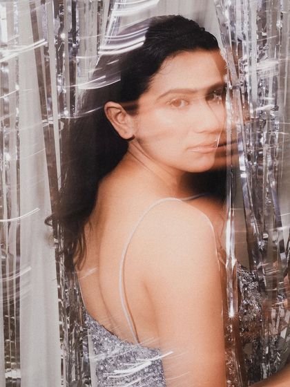 A soft, layered portrait from a birthday shoot, using reflections and a sheer curtain to create a dreamy, ethereal effect.