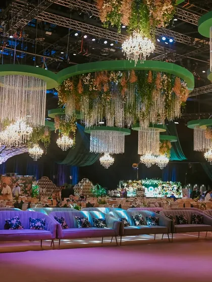 This is how I transform a grand hall into an enchanted forest. For this soirée, I suspended dozens of custom chandeliers dripping with crystals and florals from emerald green ceiling installations, creating an immersive canopy of light and opulence.