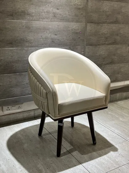 A modern barrel chair design, perfect for both dining and as an accent piece. The pleated detailing on the back adds a touch of sophistication to its clean, curved form.