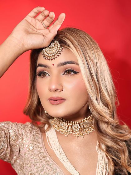 This angle highlights the sharp winged liner and the soft contouring that defines her features. It's a modern yet timeless look for any day bride.