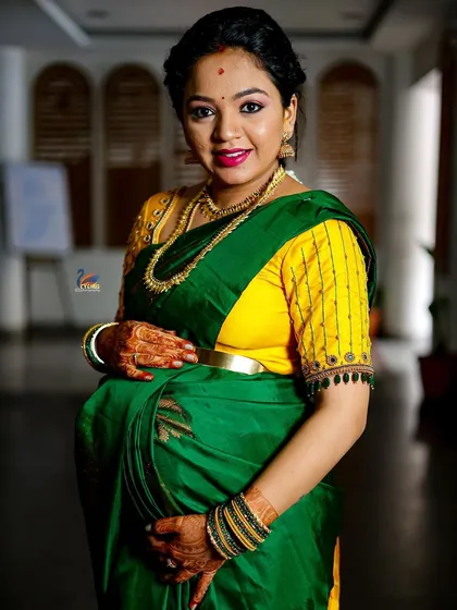 A classic portrait of a pregnant woman, gently holding her baby bump. This pose is a timeless way to remember this special phase of life.