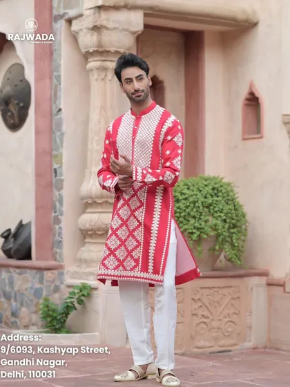 The full red kurta set, including the white pajama. This classic combination is a staple for festive occasions, elevated by the unique embroidery of the Riwayat collection.