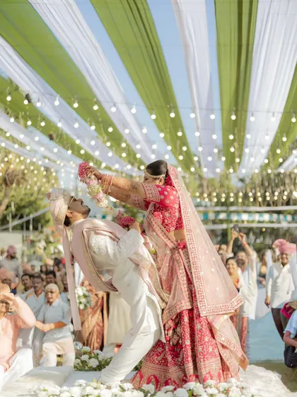 The varmala isn't just a ritual; it's a playful battle of love. I'm always ready to capture these fun, unscripted moments that show your unique chemistry and the pure joy of your shaadi.