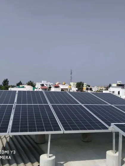 A clean solar panel installation on a residential rooftop in Sarjapur, set against the familiar Bangalore skyline. We ensure every installation is not only efficient but also aesthetically pleasing, complementing the look of your home.