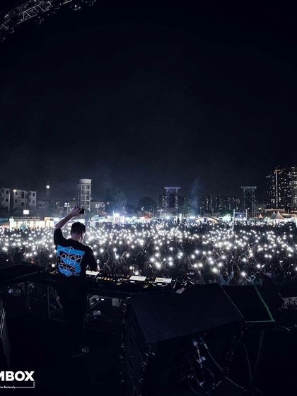 A sea of lights from the crowd's phones as Martin Garrix looks on from the DJ booth.