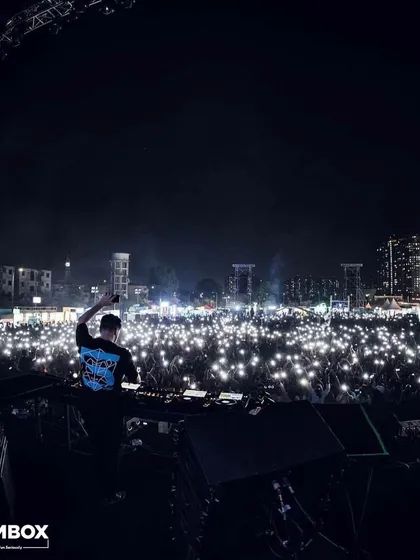 A sea of lights from the crowd's phones as Martin Garrix looks on from the DJ booth.
