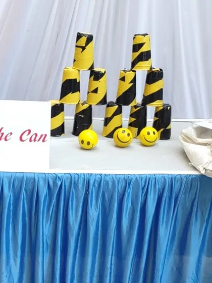 The 'Knock the Can' game is a simple but challenging classic. I provide the stacked cans and soft balls for players to test their aim and strength.