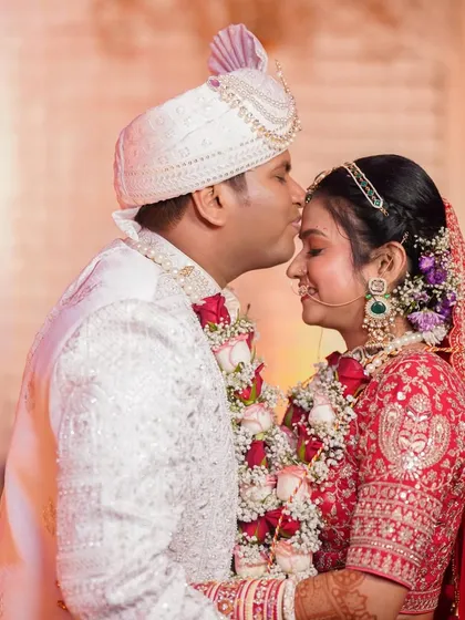 A sweet moment between the couple. The bride's makeup is flawless, with a focus on creating a romantic and timeless look for her pheras.
