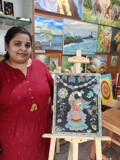 Here is my student, Sowmya, with her completed Madhubani painting of a peacock. Her work beautifully captures the detailed patterns and vibrant colors that define this traditional art form.