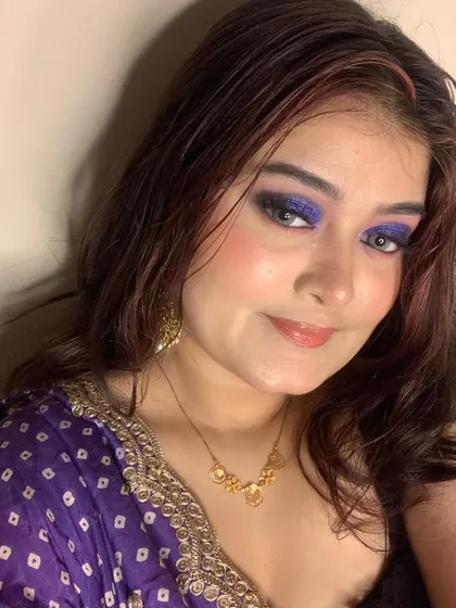 A full-face view of the purple smokey eye, paired with a soft lip to keep the focus on the eyes.