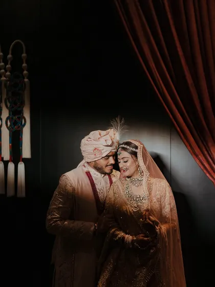 A quiet, intimate portrait of the bride and groom. Amidst the grand celebrations, we ensure there are spaces and moments for the couple to connect, captured beautifully by their photography team.