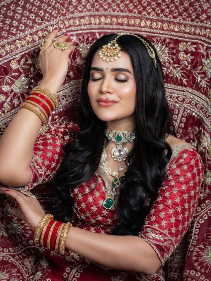 A creative shot with the bride lying on her lehenga, showcasing the intricate embroidery.