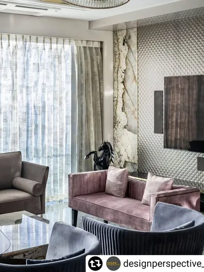 Another view of the 'Fifty Two' living room, showcasing the textured feature wall behind the television and the dramatic Patagonia marble panel.
