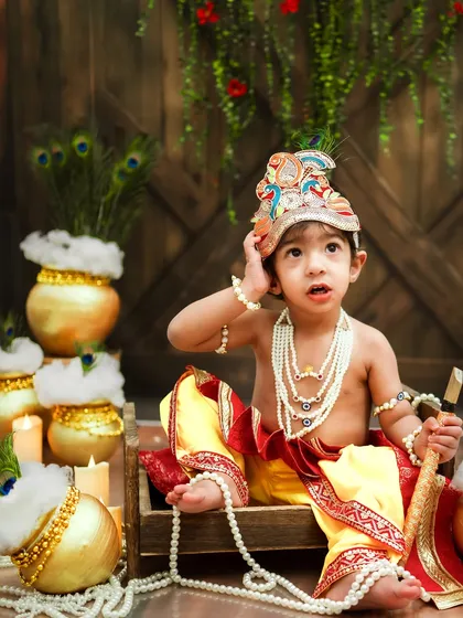 A curious glance from our little Krishna. The details in his costume and the setup come together to create a magical scene.