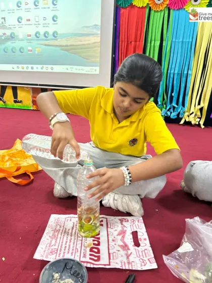 A student from KR Mangalam School carefully prepares her own bottle of bio-enzyme. This hands-on science experiment teaches the principles of fermentation and natural fertilizers.
