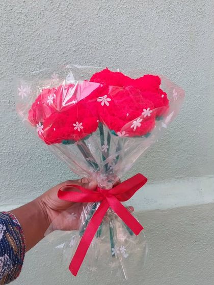 The red rose bouquet, wrapped and ready for gifting.