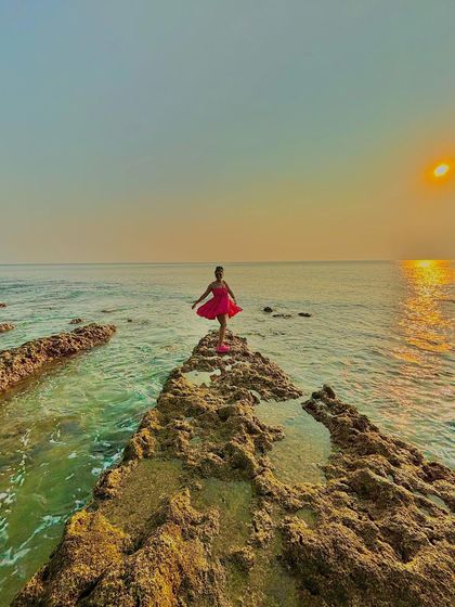 A duplicate of the balancing shot on the rocks, showcasing the stunning colors of the sunset over the ocean.
