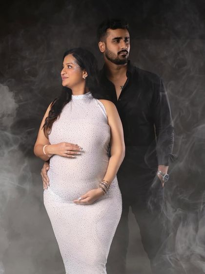 A strong and stylish couple's portrait with a dramatic smoky background, highlighting their partnership.