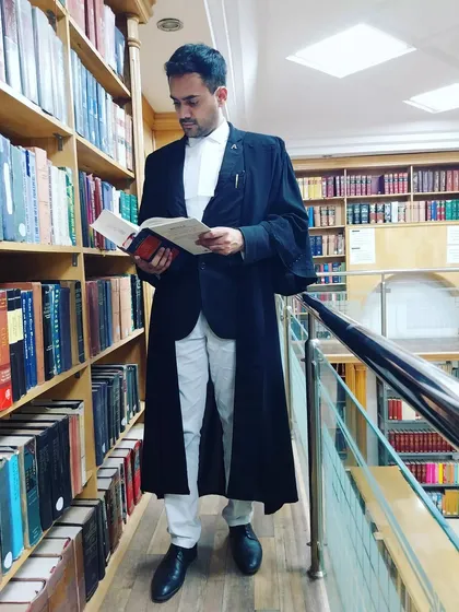 In the library of the High Court, where countless legal precedents are stored. Continuous learning and research are essential to building a strong case for my clients.