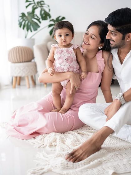 A family enjoying a relaxed moment on the floor of the studio. The soft colors create a warm and inviting atmosphere.