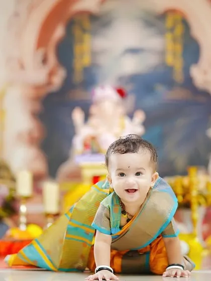 A happy crawl towards the camera. This action shot captures the playful spirit of a toddler enjoying the festive atmosphere of our Ganpati shoot.