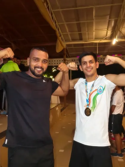 A victory pose with one of my fighters after he won his medal at the national championship in Goa.