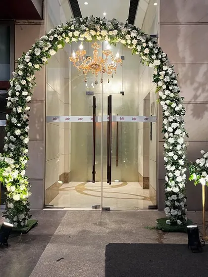Another elegant floral archway at the entrance, showing how I use consistent design elements to create a cohesive look throughout the venue.