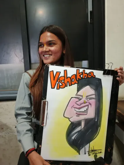 A happy guest named Vishakha with her new portrait. The bold colors and name lettering make it a great keepsake.