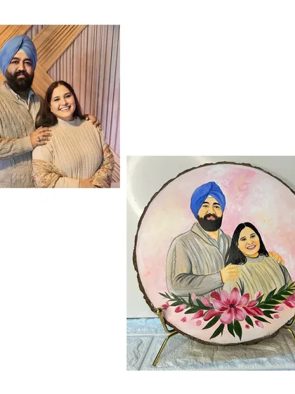 A warm and loving couple portrait painted on a natural wood slice. The soft pink background and lily floral arrangement at the bottom add a touch of elegance to this custom piece.