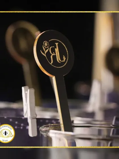 A close-up of our custom-designed stirrers, featuring the couple's initials. It's a simple, elegant way to personalize the bar experience for your wedding.