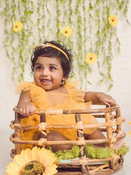 Celebrating a half birthday. This sunny sunflower setup is perfect for marking six months, capturing that happy, curious stage.